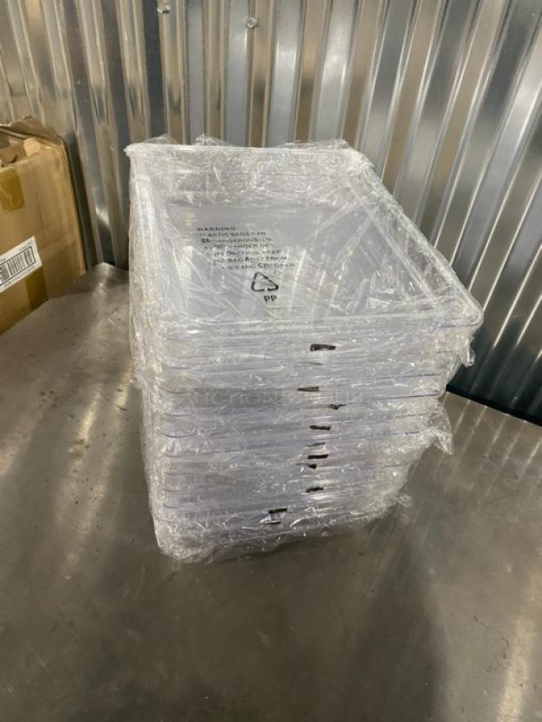 Brand new Winco SP7202 clear polycarbonate 1/2-size food pan, 2.5" deep, wrapped, showing recycling symbol and warnings.