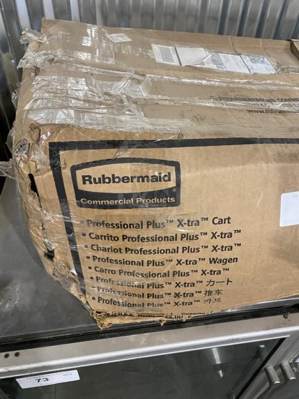 Brand new Rubbermaid Commercial black 3-tier utility cart with casters. Original packaging, showing item labels and branding.