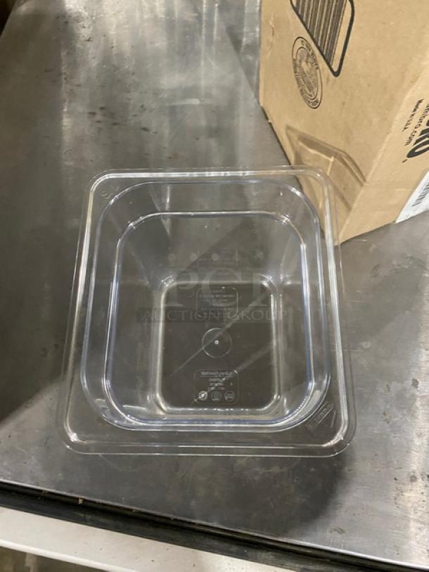 Brand new Cambro Camwear 1/6-size clear polycarbonate food pan, 6" deep, model 66CWTRI135, on metal surface.