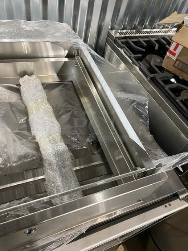 Brand new NBR TDR-2020L stainless steel self-closing drawer assembly with lock and key, wrapped in protective plastic.