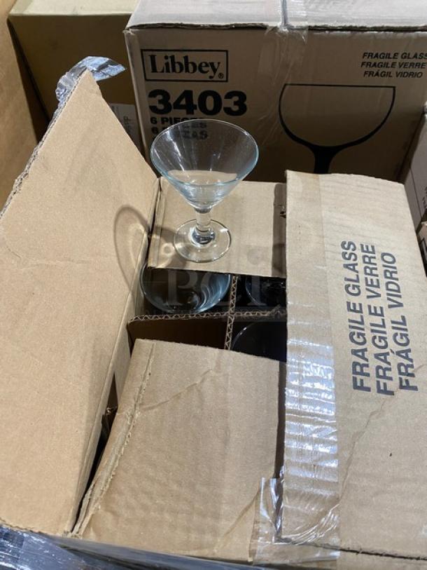 Mixed pallet of Libbey glassware, including 38 oz. Super Bowl Glasses, 11.5 oz. Wine Goblets, 3 oz. Mini Martini Glasses, in original packaging.