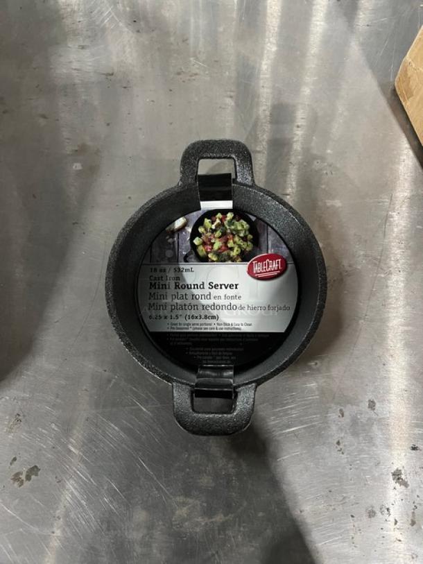 TableCraft Model CW30142 round cast iron server, 18 oz, pre-seasoned, brand new, with label detailing features.