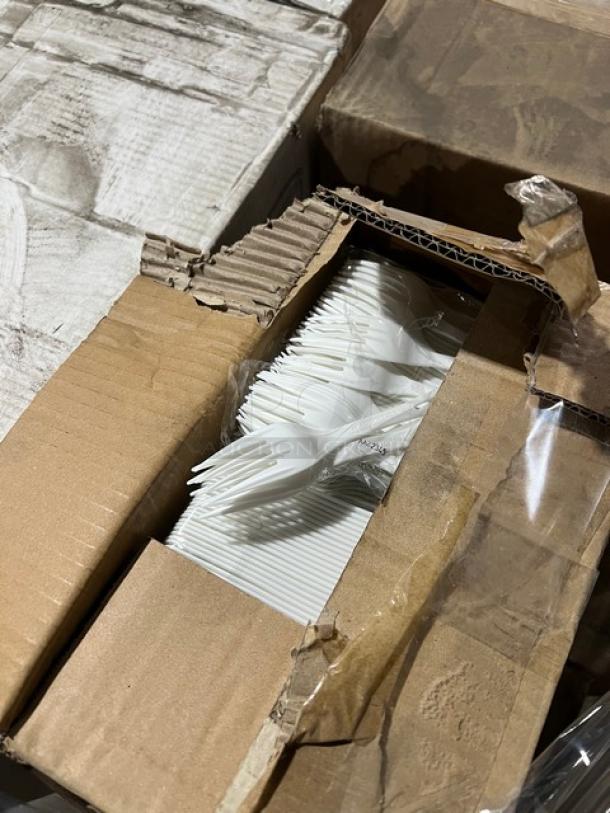 Mixed pallet including white compostable forks in open cardboard box, brand new.