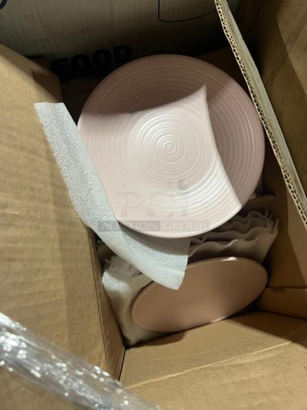 Mixed pallet featuring Hoffmaster 13"x17" traymats, AmercareRoyal 32 oz. containers, Steelite black plates, and pink coupe plates.