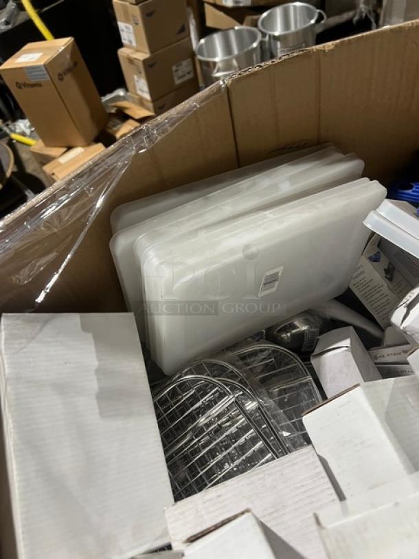 Mixed pallet with various commercial kitchen items including white porcelain plates, aluminum lids, and syrup servers.