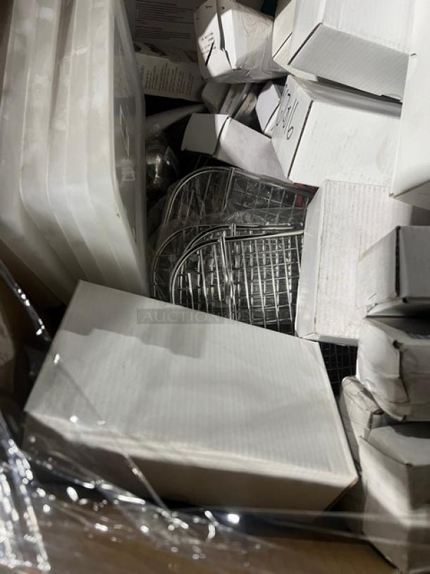 Mixed pallet of new commercial kitchenware in boxes, including Yanco plates, Vollrath lids, and syrup servers.