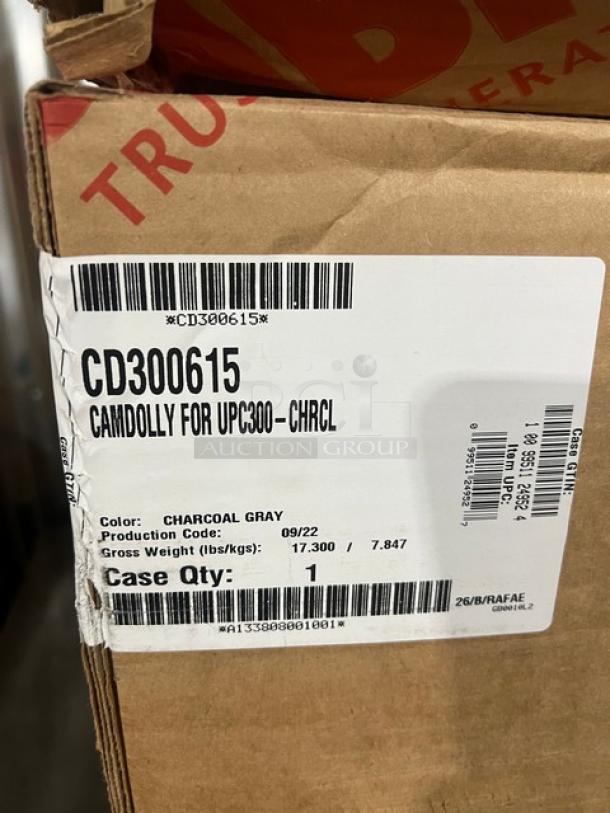 Brand new Cambro CD300615 Camdolly, charcoal gray, heavy-duty, 350 lb capacity, on casters. Tags indicate model and specs.