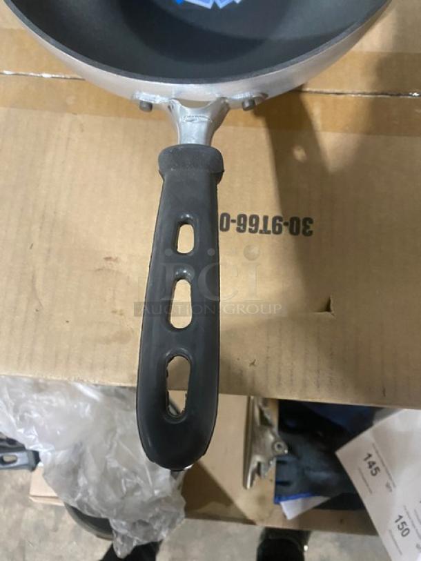 Brand new Vollrath 11" stir fry pan, model 68120. Features non-stick Steel Coat x3, black grip handle.