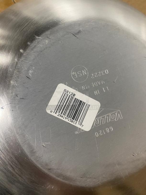 Vollrath 11" round aluminum stir fry pan, model 68120, with Steel Coat x3, black grip handle, and barcode sticker visible.