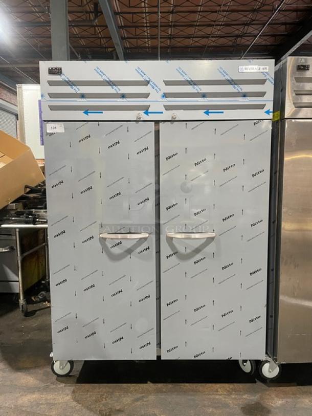 Beverage-Air TMF2HC-1S 54" stainless steel 2-door top-mount freezer, like new, on casters, with protective wrap visible.