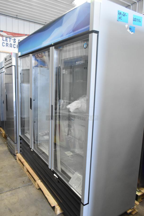 Brand new 2026 Hoshizaki RM-65-HC commercial three-door reach-in cooler, 115 volts, 1 phase, stickers visible.