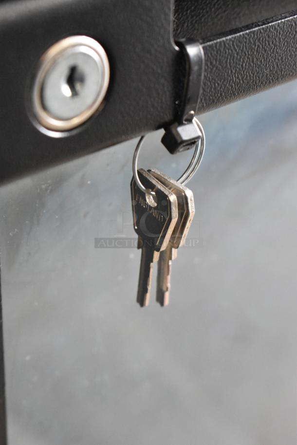 Keys for a 2022 Hoshizaki BB95-G Commercial 3 Door Back Bar Cooler, shown in a lock.