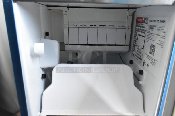 Brand new 2025 Hoshizaki AM-50BAK-AD Top Hat Cuber Ice Machine, 115V, 1 Phase. Interior view with labels visible.
