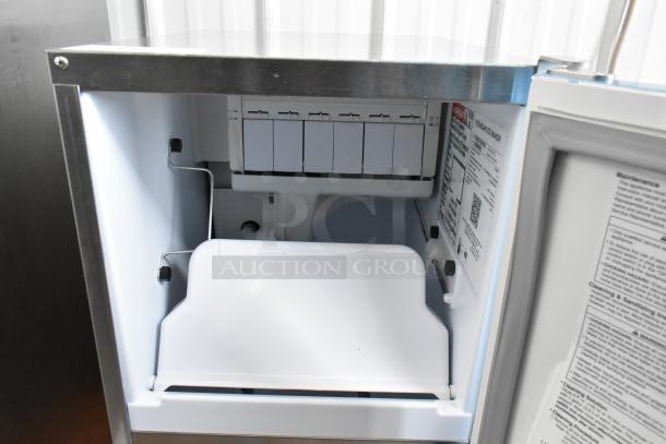 BRAND NEW 2025 Hoshizaki AM-50BAK-AD ice machine, 27 lb. bin, 115V, 1 phase. Interior view with labels.