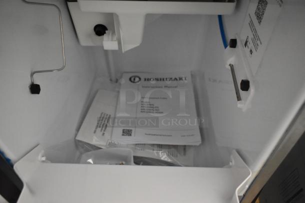Brand new 2024 Hoshizaki AM-50BAJ-DS icemaker interior with manuals, 115 volts, 1 phase, pristine condition.