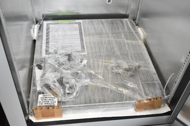 Brand new 2025 Hoshizaki EF1A-FS single door commercial freezer, 115V, with packaging and setup instructions visible.