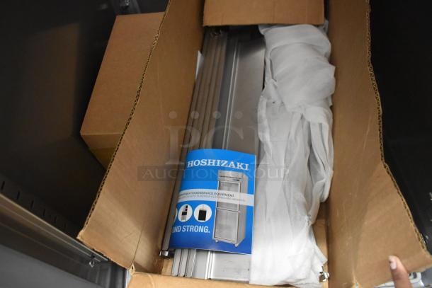 Brand new 2026 Hoshizaki PT1A-FS-FS single door reach-in cooler in packaging, 115 volts, 1 phase, with product brochure.
