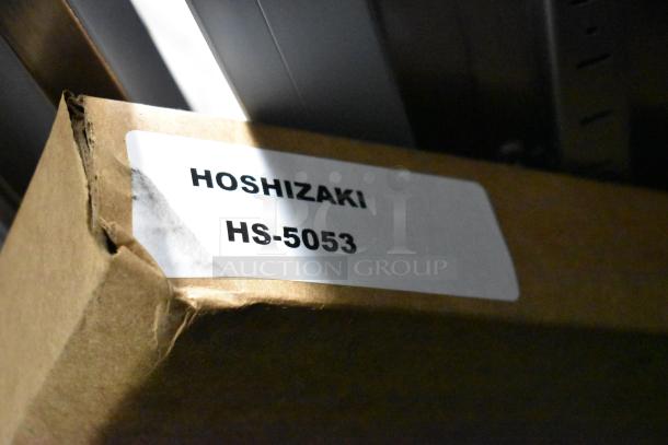 Cardboard box with "Hoshizaki HS-5053" label, possibly indicating packaging contents related to the Hoshizaki brand.