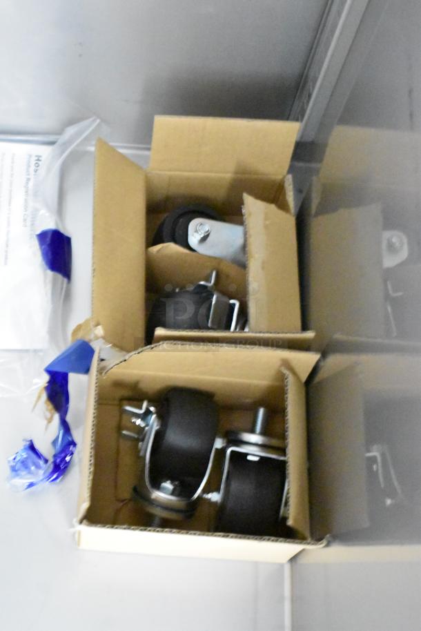 Boxes of commercial casters for Hoshizaki R1A-FSL cooler, brand new condition, shown with product registration card.