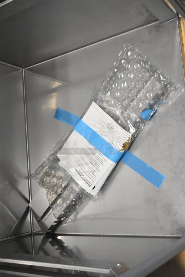 Brand new 2026 Hoshizaki RN1A-FS commercial single door reach-in cooler interior, showing packaging and documents.