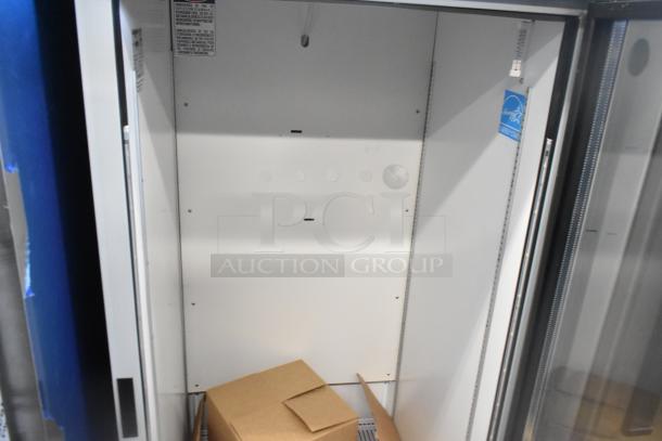 BRAND NEW! 2023 Hoshizaki RM-26-HC-L Commercial Single Door Cooler, 115V, 1 Phase, interior view with labels and a box.