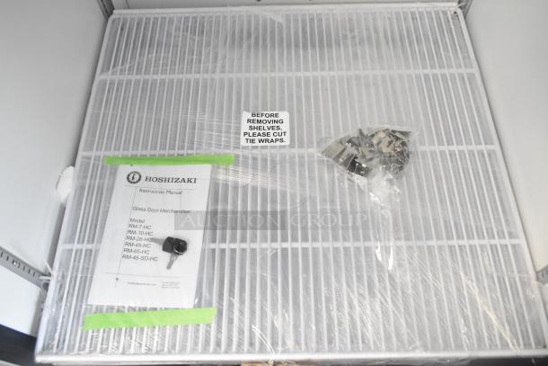 Brand new 2024 Hoshizaki RM-26-HC-L single door cooler, 115V, with keys and instruction manual taped to shelf.