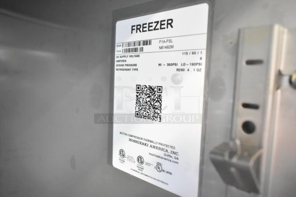 Alt text: Hoshizaki F1A-FSL commercial freezer label, showing model, serial number, voltage, refrigerant type, and certifications.