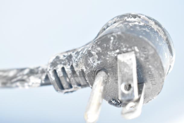 Close-up of a power plug with visible wear and residue; likely associated with a True GDM-12-HC-LD cooler.