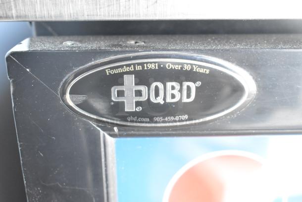 QBD DC6LP Commercial Mini Cooler with a single glass door, 115 volts, label showing brand and model details.