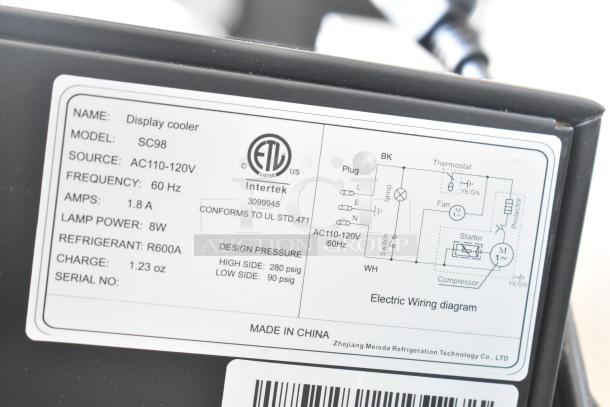 Label on SC98 Commercial Single Door Mini Cooler Merchandiser detailing specs: 115V, 1.8A, R600A refrigerant, ETL listed.