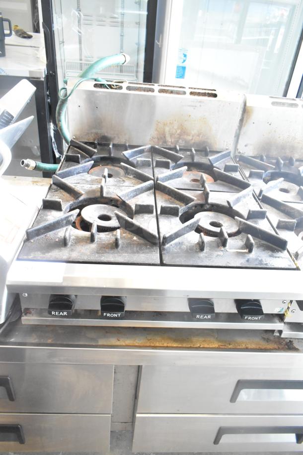 BT60-4N Commercial Gas 4 Burner Range, used condition, model BT60-4N, with control knobs labeled "Rear" and "Front."