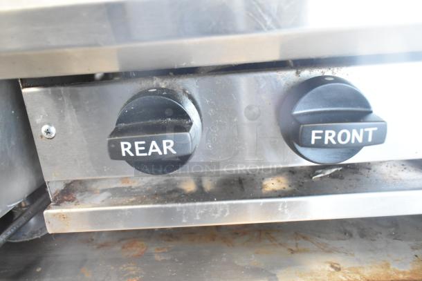BT60-4N Commercial Gas Range control knobs labeled "Rear" and "Front," stainless steel surface, showing wear.