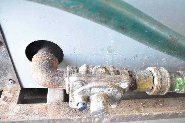 Close-up of gas connection on BT60-4N Commercial Gas Powered 4 Burner Range, showing signs of rust and wear.