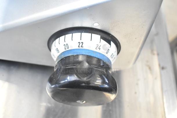 Bizerba SE 12 US meat slicer adjustment knob, showing marked dial for precise thickness settings.