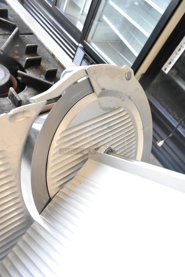 Bizerba SE 12 US commercial meat slicer with blade sharpener. Countertop model, 120 volts, 1 phase. Good condition.