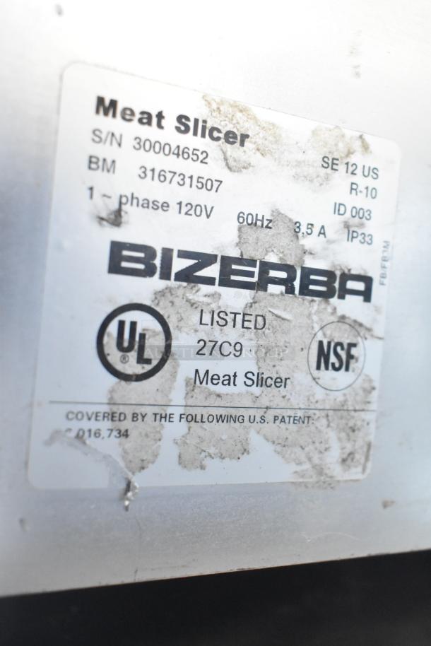 Bizerba SE 12 US commercial meat slicer label showing model, serial number, 120V, 1 phase, UL and NSF listed.