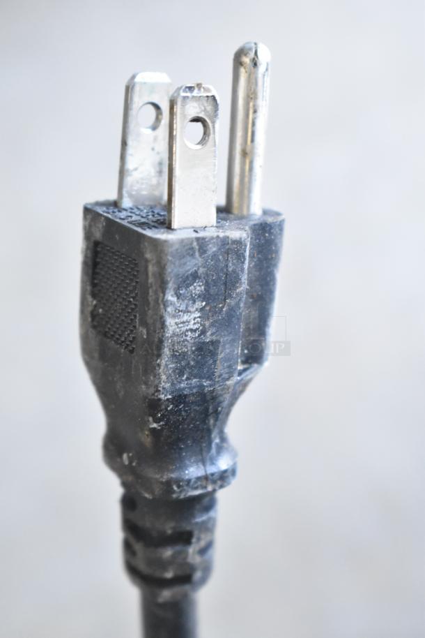 Close-up of a black power plug for the Coldline CB-72 commercial chef base. Visible scuffing indicates use.