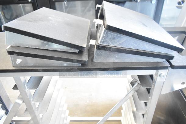 Commercial double pan rack on casters, metal finish, sturdy design, visible wear. Ideal for kitchen use or catering.