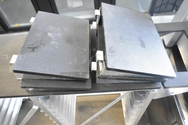 Commercial double pan rack on wheels with multiple slots for pans, in good condition. Includes sturdy construction ideal for kitchens.