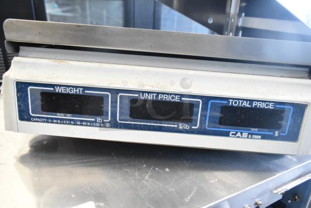 CAS S-2000 scale with 30 lb. capacity, digital display for weight, unit, and total price, showing signs of wear.