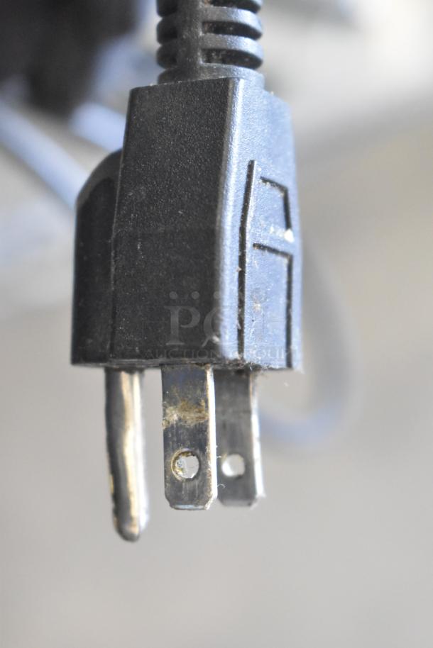 Close-up of a black electrical plug attached to the CAS S-2000 scale. Plug shows minor wear and dust.