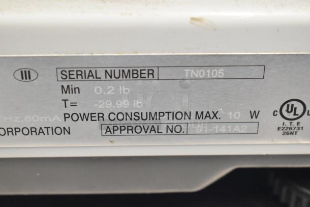 CAS S-2000 scale label showing serial number TN0105, 0.2 to 29.99 lb capacity, 10W max power, UL approval.