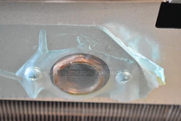 Hoshizaki KMD-410MAJ commercial ice machine detail showing copper component, 115 volts, showcasing sturdy construction.