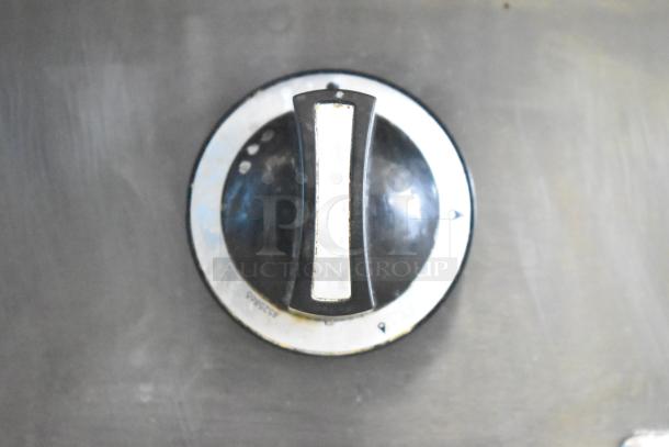 Garland Commercial Griddle knob close-up, showing temperature dial with some wear. Ideal for precise heat control in cooking.