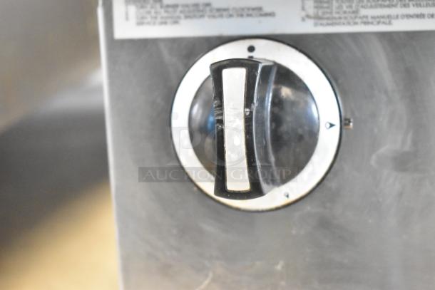 Garland Commercial Flat Top Griddle control knob, featuring a black and silver design with setting indicators.