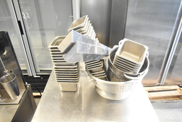 Stainless steel drop-in bins and colander set. Includes 47 items, excellent condition, ideal for kitchen use.