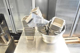 Stainless steel drop-in bins and colander set. Includes 47 items, excellent condition, ideal for kitchen use.