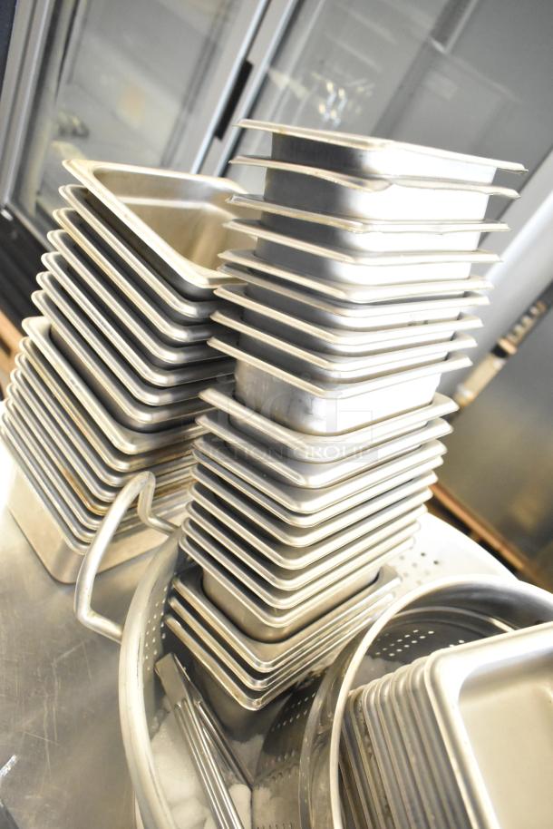 Stainless steel drop-in bins and colander, set of 47. Used condition. Ideal for commercial kitchen use.