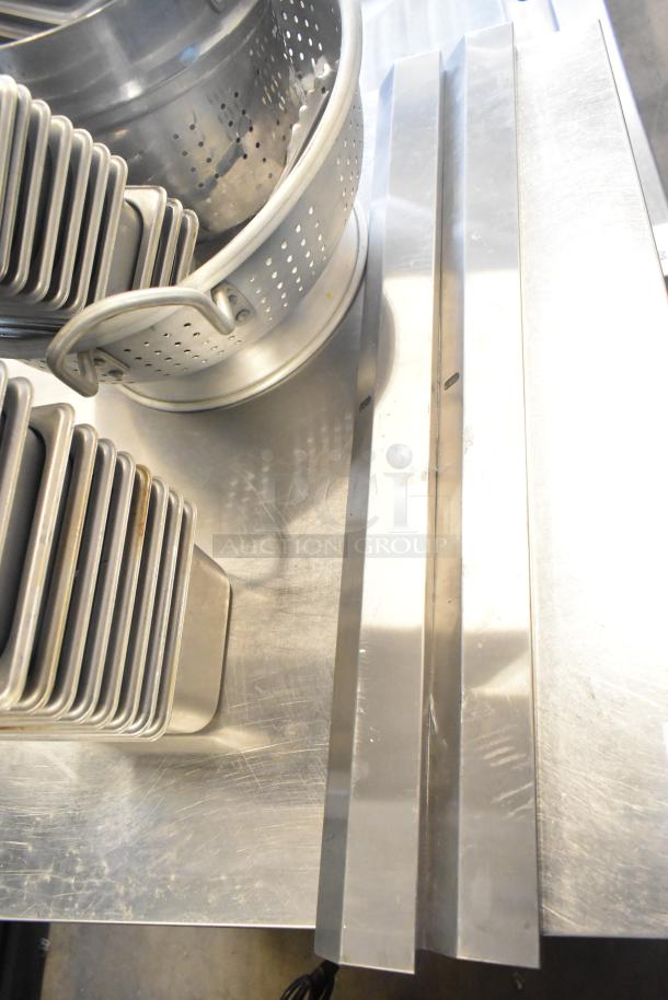 47 stainless steel items, including stackable drop-in bins and a colander, in good condition. Auction lot enhances bid value.