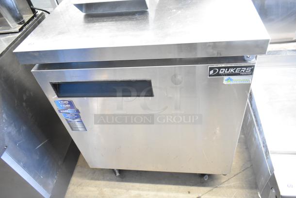 Dukers DUC29F commercial single door undercounter freezer with stainless steel finish, on casters. Features warranty label.